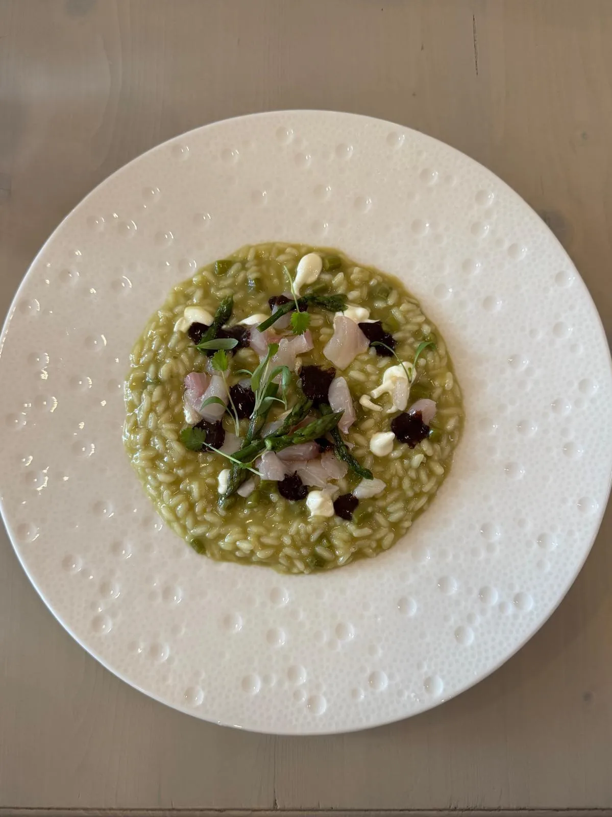 Green asparagus risotto with crudo at a Cefalù restaurant