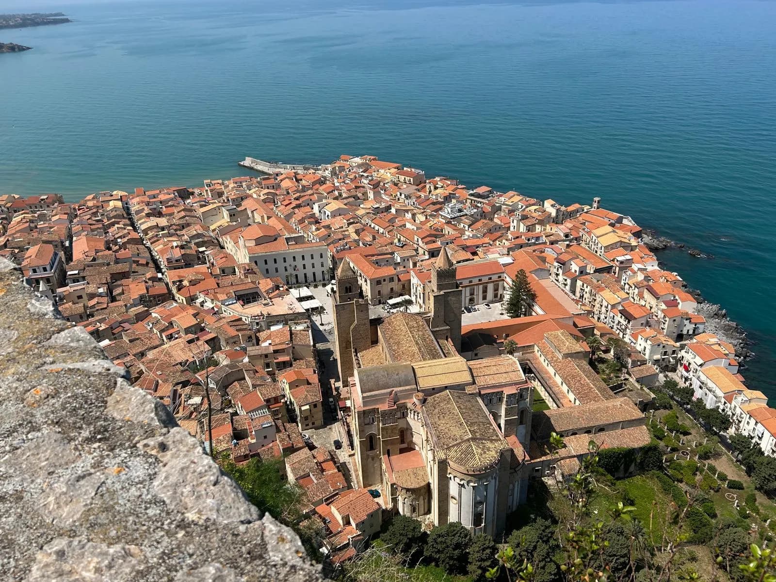 Aerial view of Cefalù rooftops and cathedral from La Rocca