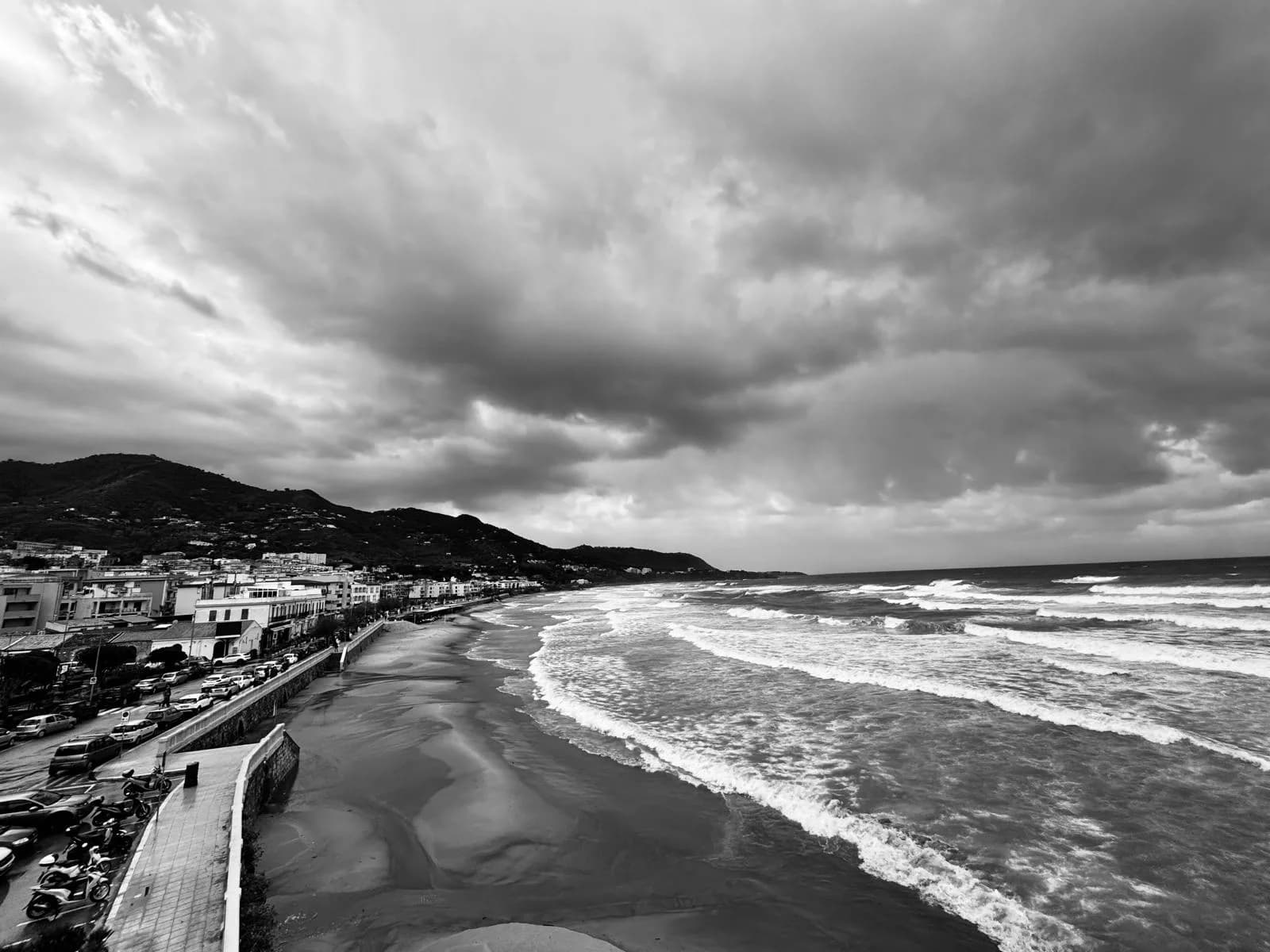 Storm clouds and rough surf over the Lungomare beach in winter