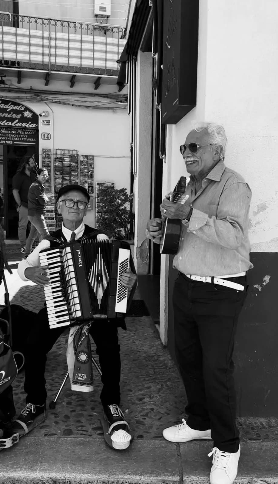 Street musicians playing accordion in the lanes of Cefalù old town