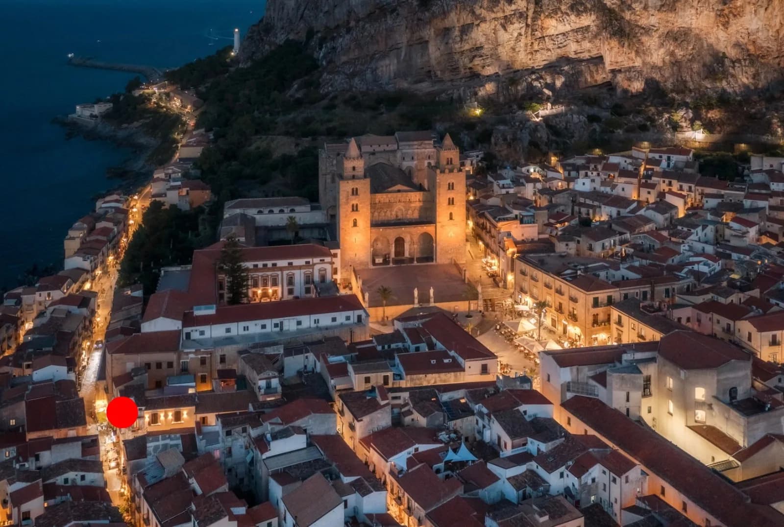Cefalù Cathedral and the floodlit old town at night beneath the Rocca, near The Lavender Townhouse