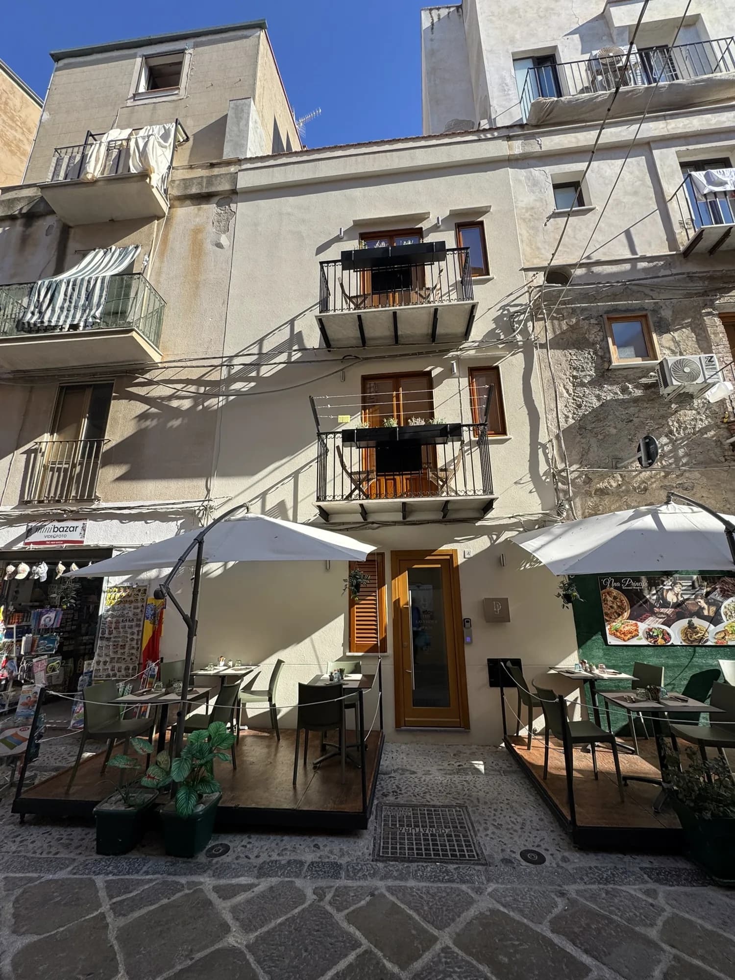 The Lavender Townhouse on Via Candeloro, with café tables in the lane below