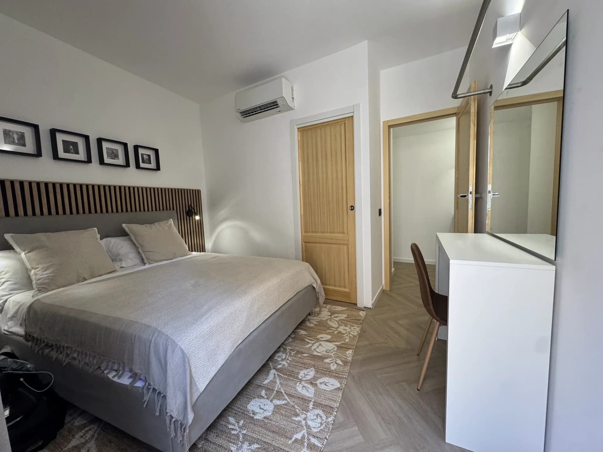 Bedroom with a writing chair, air conditioning and an ensuite doorway