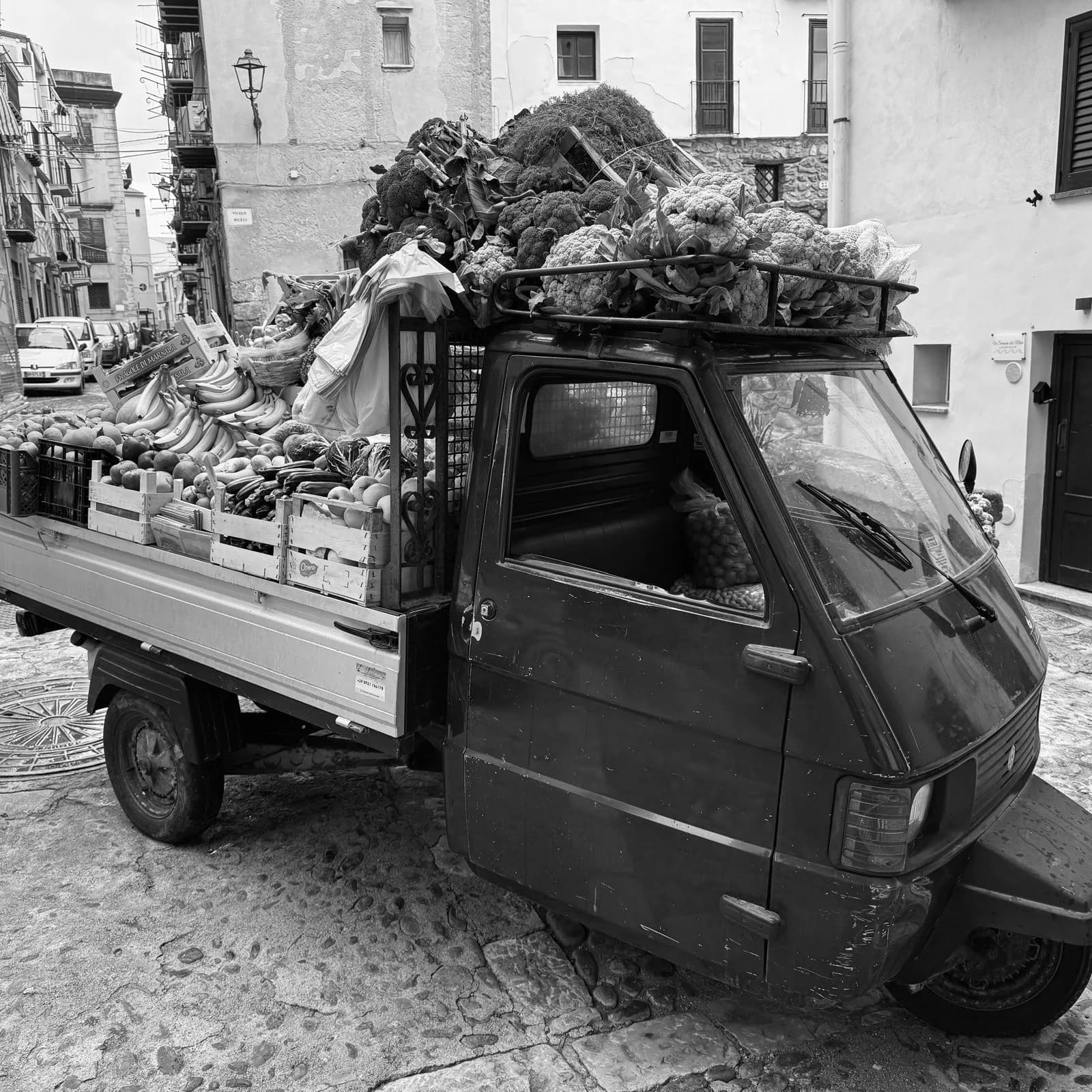 Ape truck loaded with fresh produce in the streets of Cefalù