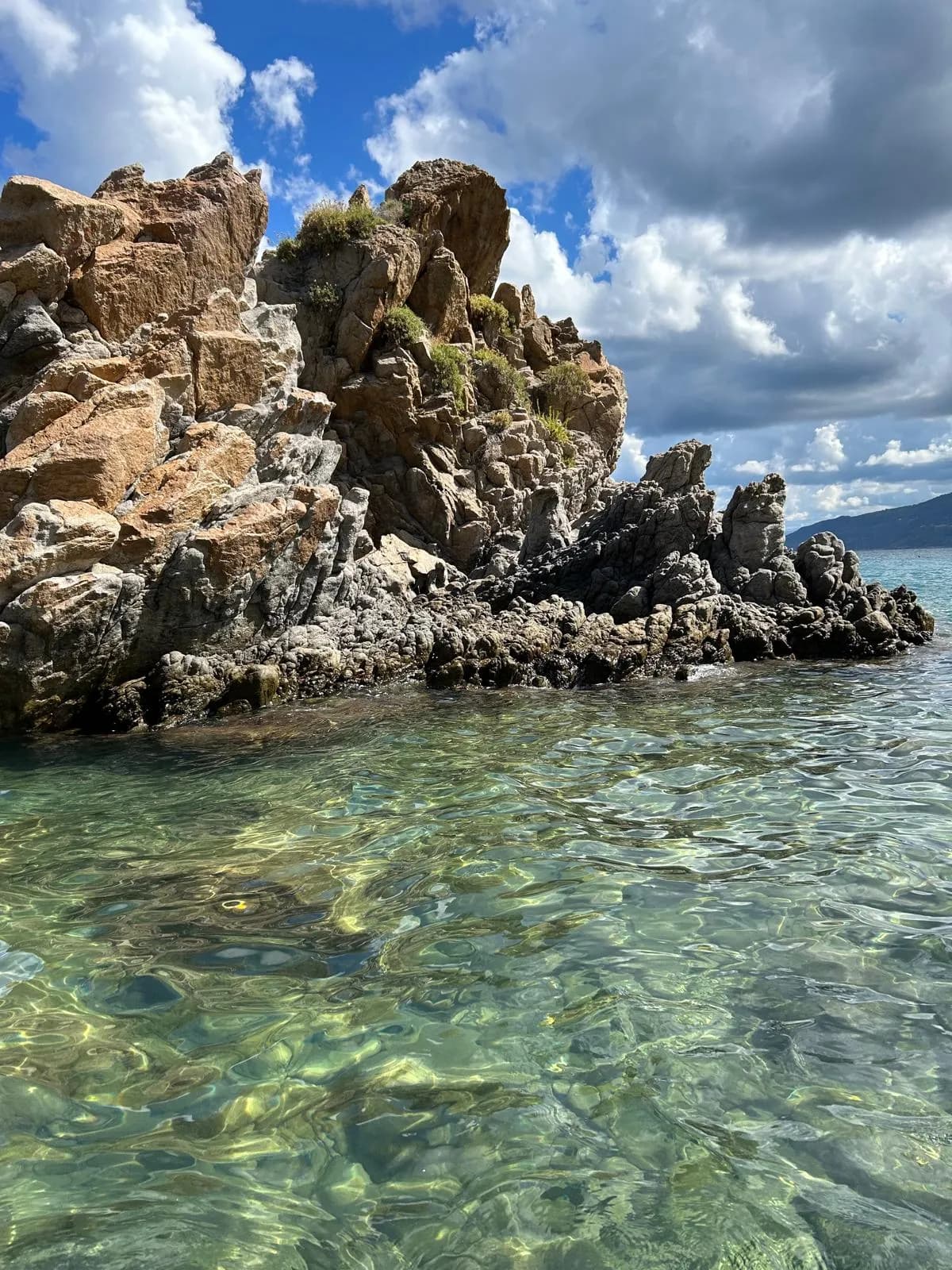 Crystal clear water around rock formations near Kalura cove