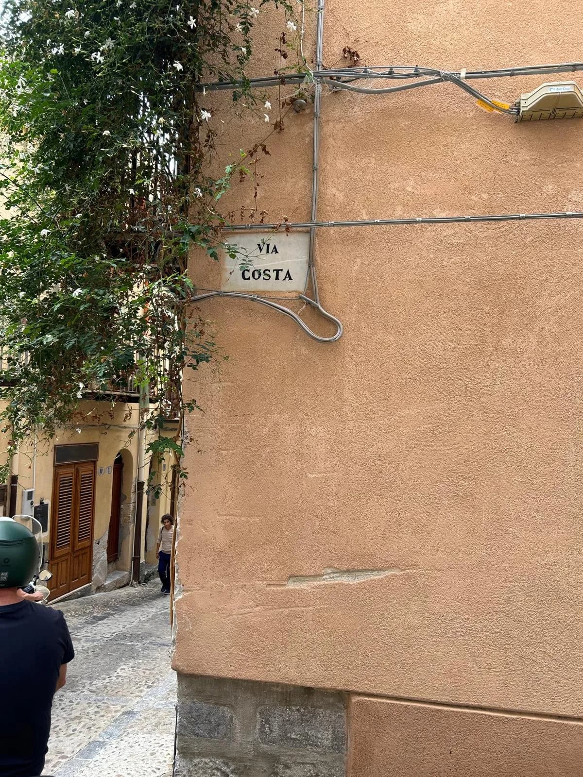 Via Costa street sign on a terracotta wall in the old town