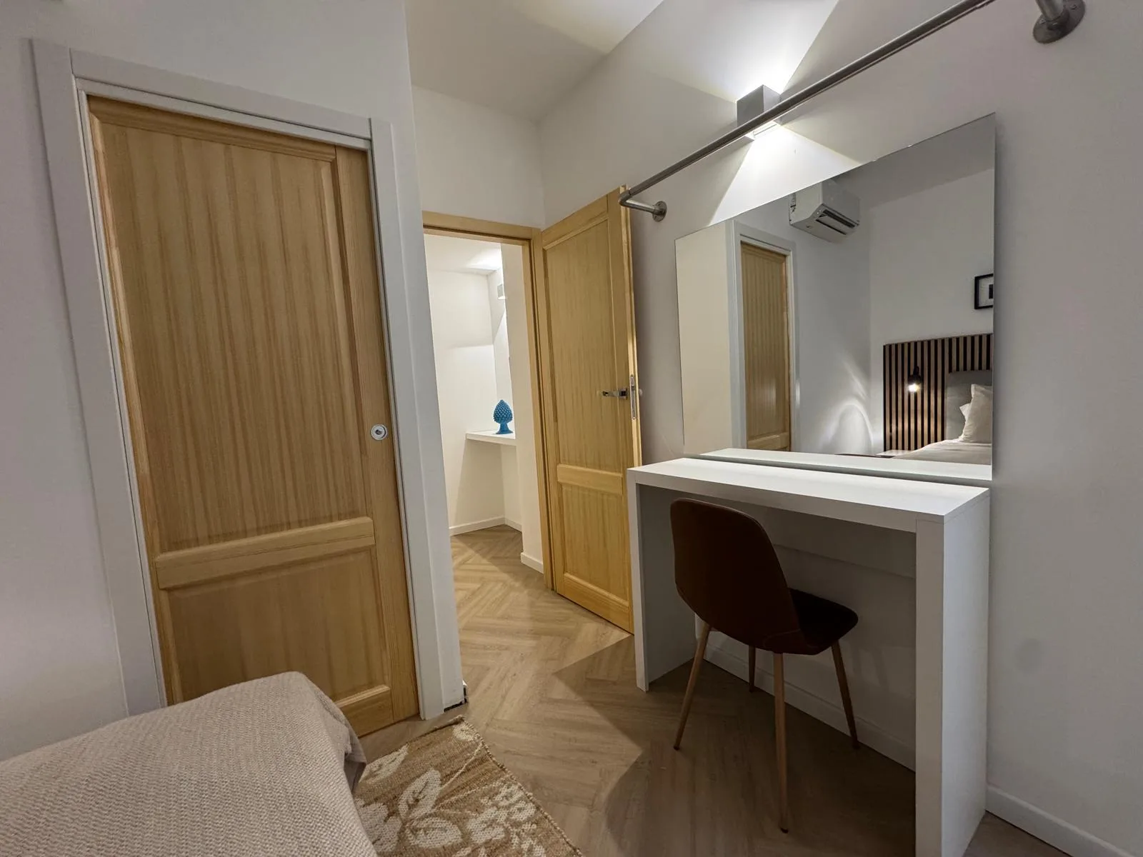 The dressing area at The Lavender Townhouse — a vanity desk and mirror in soft light